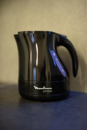 a black coffee cup sitting on a table at Spacious Fully Equipped 3BD 2Bath Apt in the heart of city with Balconies AC and fast WIFI #1 in Heraklio Town