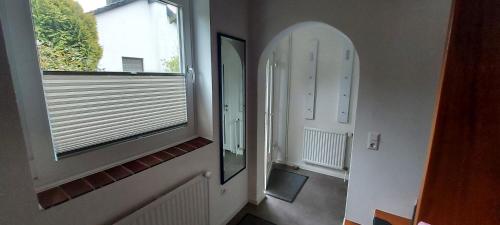 a hallway with a mirror and a window at Ferienwohnung in Bad Segeberg