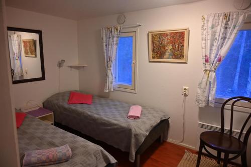 a bedroom with two beds and a window at Hostel Ukonlinna in Imatra