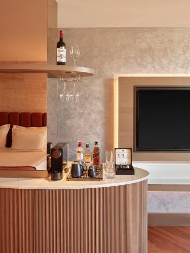 a hotel room with a bar with a flat screen tv at Lara Barut Collection-Ultra All Inclusive in Lara