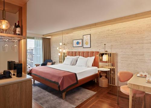 a hotel room with a bed and a living room at Lara Barut Collection-Ultra All Inclusive in Lara