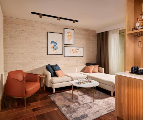 a living room with a couch and a table at Lara Barut Collection-Ultra All Inclusive in Lara