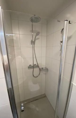 a shower with a glass door in a bathroom at Gehobenes Apartment mit Balkon in Reutlingen