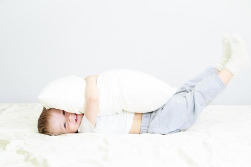 a little boy laying on a bed with a cloud on his head at Boutique Hotel Seidenhof in Zürich