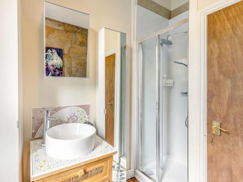 a bathroom with a sink and a shower at Central Tod Cottage in Todmorden