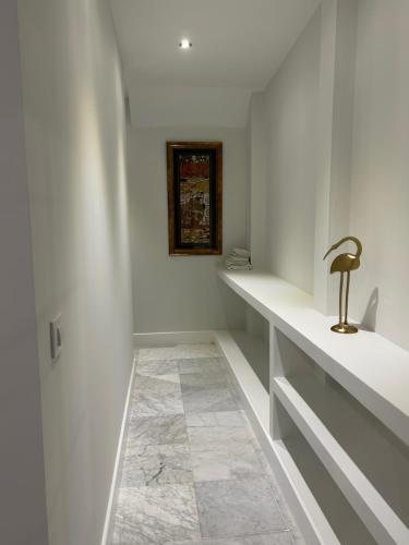 a bathroom with white walls and a sink and a counter at Olavide Premium Apartments in Seville