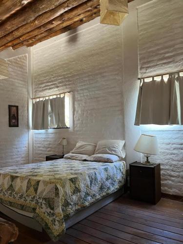 a bedroom with a bed and a window at BanTelmo in Juana Koslay 