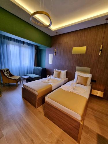 a hotel room with two beds and a couch at Dream House Hotel & Spa in Kolašin