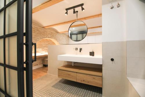a bathroom with a sink and a mirror at RentalSevilla Magia en San Esteban in Seville