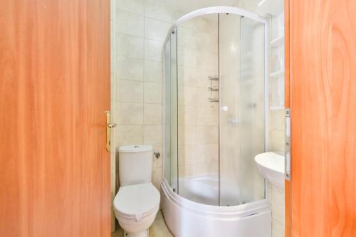 a bathroom with a shower and a toilet and a sink at Garni Hotel Koral in Budva