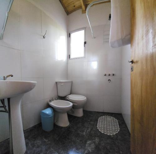 y baño con aseo y lavamanos. en Cabaña Itu en Ituzaingó