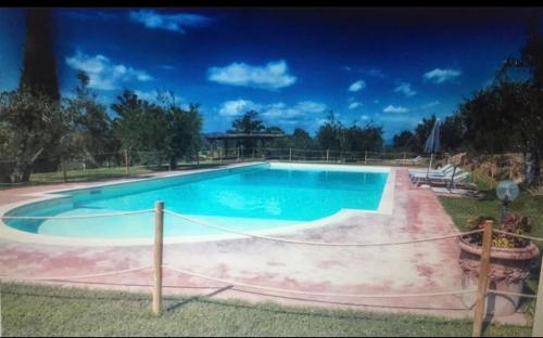 a large swimming pool with a rope around it at Locanda di Santantimo in Chiassa Superiore