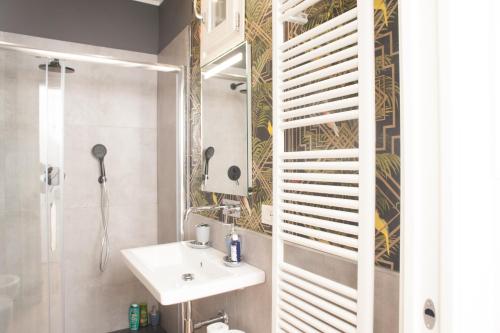 a bathroom with a sink and a mirror at Santantonio Suite, Porta Susa in Turin