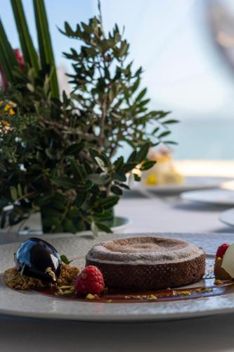 a chocolate cookie and berries on a plate on a table at Royal Tulip Korbous Bay Thalasso & Springs in Qurbuş