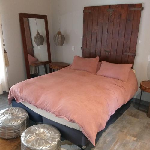 1 dormitorio con 1 cama grande con manta naranja en CASA LOS CASTAÑOS en Tafí del Valle