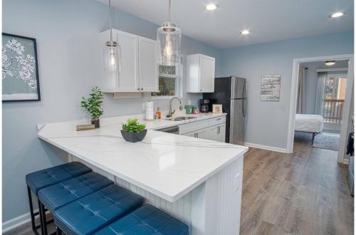 a kitchen with a large white counter and blue cabinets at Adorable 4BR 2BA Close to Riverwalk and Downtown in San Antonio