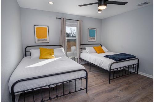 a bedroom with two beds and a window at Adorable 4BR 2BA Close to Riverwalk and Downtown in San Antonio