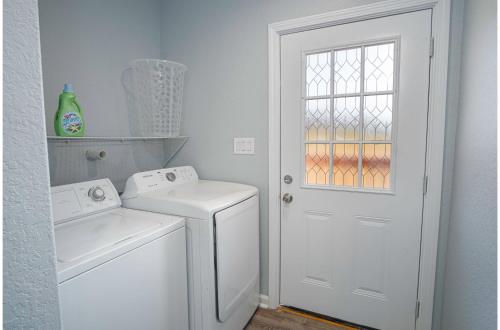 a white laundry room with a washer and dryer at Adorable 4BR 2BA Close to Riverwalk and Downtown in San Antonio