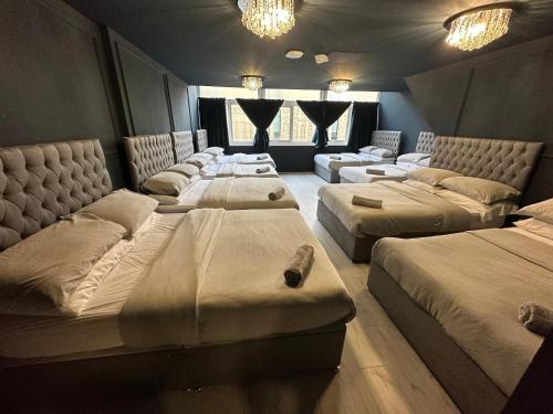a room with four beds in a room at Unique city centre DJ apartment - sleeps 20 in Liverpool