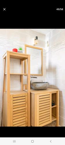 a bathroom with a sink and a mirror at Villa 6 couchages spa privatif, accès direct mer, piscine in Le Barcarès