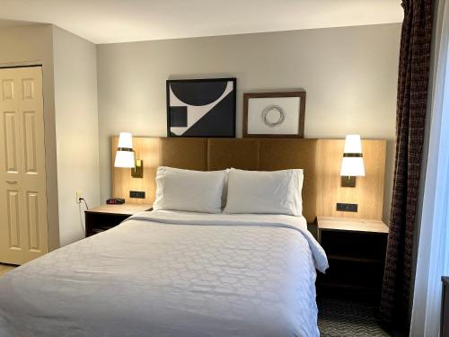 a hotel room with a large bed and two lamps at Staybridge Suites Milwaukee West-Oconomowoc, an IHG Hotel in Oconomowoc