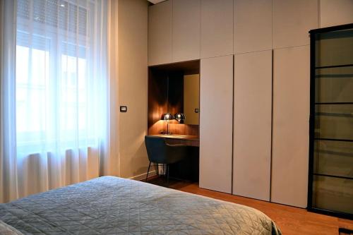 a bedroom with a bed and a desk and a window at Nino Luxury Apartment in Zagreb