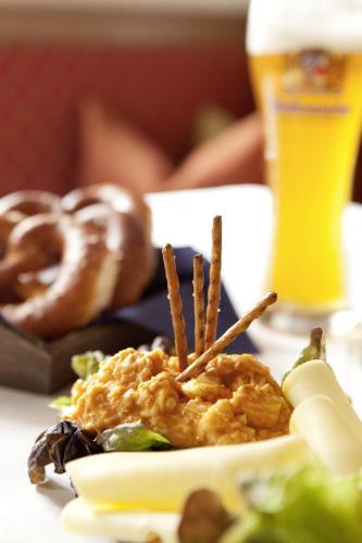 a plate of food on a table with a glass of beer at Gasthof Lerner in Freising