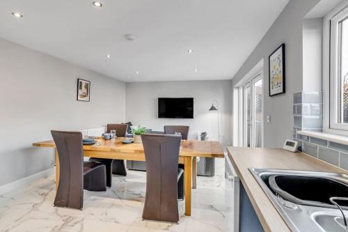 a dining room with a wooden table and chairs at 8 Beds Denmark House in Norwich