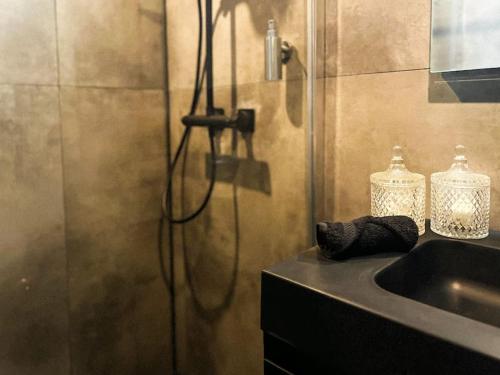 a shower in a bathroom with a sink at Cannelle in Verviers