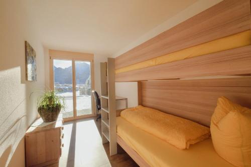 Schlafzimmer mit einem Bett und einem Fenster in der Unterkunft Châlet Bärgfride in Kandersteg