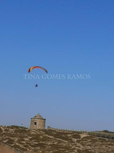 a kite flying in the sky over a building at Casa Ramos in Póvoa de Varzim