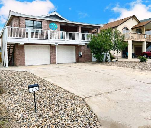 a house with a sign in front of it at Sleeps 22, 7 bedrooms, 2min walk To The Beach, Private Heated Pool and Hot Tub, Zula Del Mar South Padre Island Texas in South Padre Island