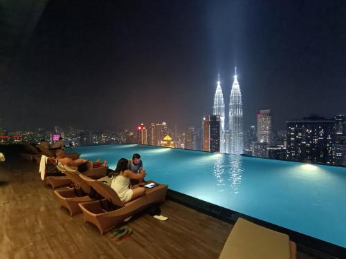 a pool on the roof of a building at night at Platinum 2 KLCC NewLuxuryCondo By Langitel with InfinityCityView SwimmingPool in Kuala Lumpur