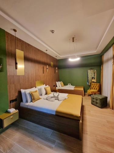a large bedroom with two beds and a chair at Dream House Hotel & Spa in Kolašin