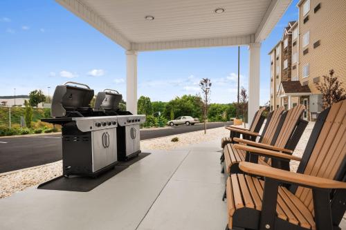 a patio with a grill and chairs on a porch at Microtel Inn & Suites by Wyndham in Lynchburg