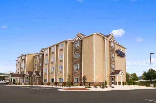 a large apartment building with a parking lot at Microtel Inn & Suites by Wyndham in Lynchburg