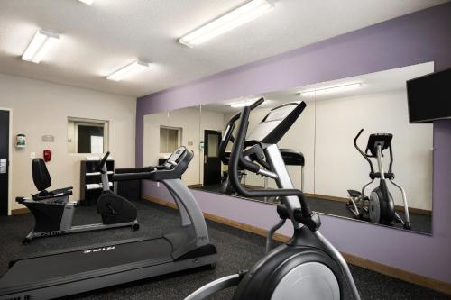 a gym with two exercise bikes and a mirror at Microtel Inn & Suites by Wyndham in Lynchburg