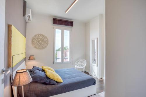 a bedroom with a blue bed and a window at #24 Marie-Claire Suite Sea view/balcony/AC/5min port in Villefranche-sur-Mer