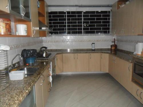 a kitchen with a sink and a counter top at Casa e Salao Botanico in Curitiba