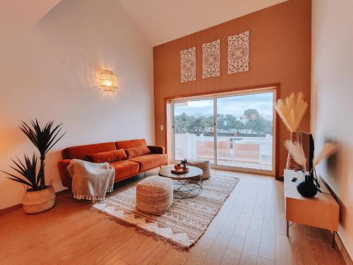 a living room with a couch and a large window at Penthouse at Cabedelo Beach with Ocean View in Viana do Castelo