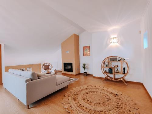 a living room with a couch and a mirror at Penthouse at Cabedelo Beach with Ocean View in Viana do Castelo