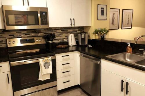a kitchen with a stainless steel stove and a microwave at SunSet Terrace, Avon NC in Avon