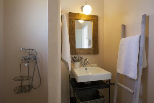 a bathroom with a sink and a mirror at Kallisti Elia · Serene holiday villa - Views, nr Best family Beach in Naousa