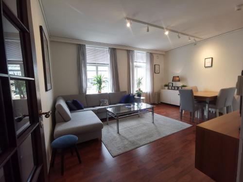 a living room with a couch and a table at Inner City Center in Bergen