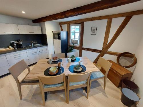 a kitchen with a wooden table and chairs in a room at Gasthaus zum Ochsen in Mönchberg