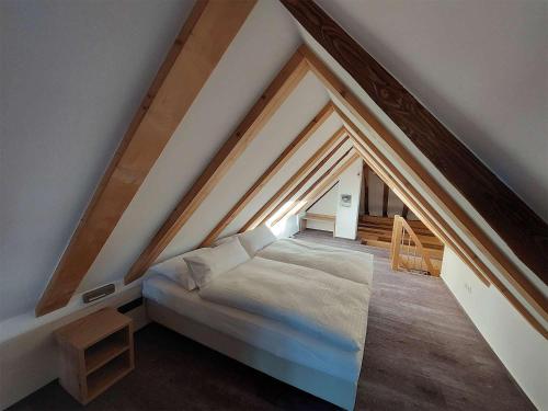 a bedroom with a bed in a attic at Gasthaus zum Ochsen in Mönchberg