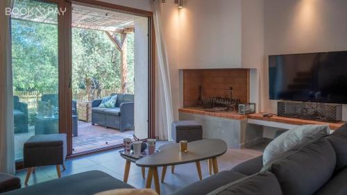 a living room with a couch and a tv at Villa Colombo in Bonifacio