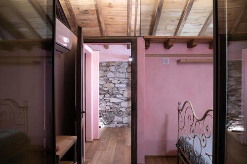 a room with a bench and a stone wall at Home Cà D'la Butina in Mergozzo
