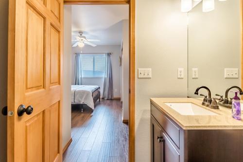 a bathroom with a sink and a bedroom with a bed at European Escape in Leavenworth
