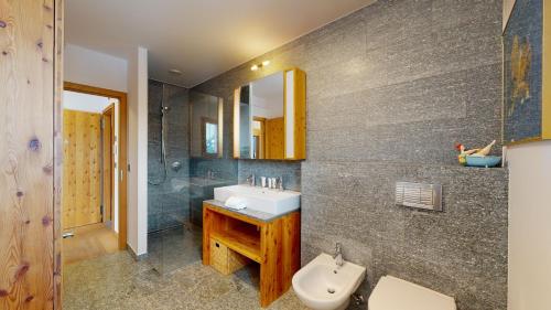 a bathroom with a sink and a mirror at Etoiles des Neiges LUXE & JACUZZI chalet 12 pers by Alpvision Résidences in Hérémence